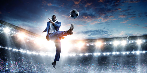 Fototapeta na wymiar Soccer businessman in action with ball. Mixed media