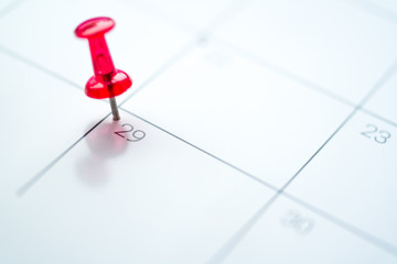 Red push pin on calendar 29th day of the month