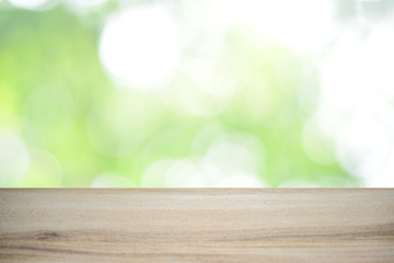 wood table over green bokeh background with copy space for your text