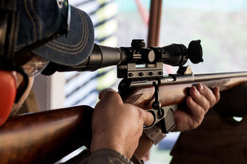 a man takes aim at a shooting range.