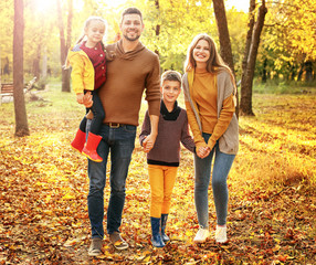 Fototapeta premium Happy family walking in autumn park