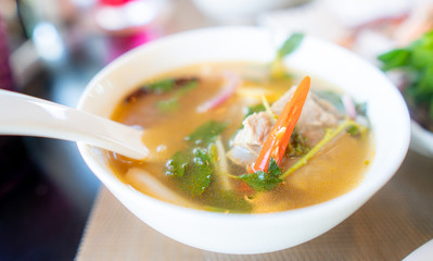 delicious hot and sour soup in white bowl ,select focus.