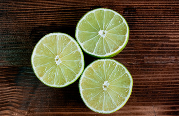 Lime slices on a wood background