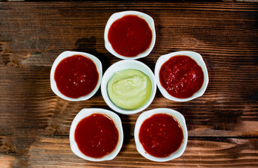 Bowls with guacamole and salsa on the wood background. Top view.