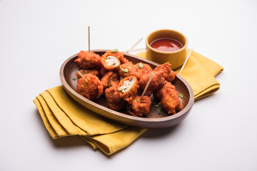 Mushroom 65, starter or appetiser food recipe from India. served in a plate with ketchup. selective focus