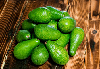 isolated avocado on a dark wood and white background. selective focus