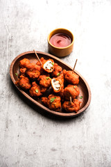 Mushroom 65, starter or appetiser food recipe from India. served in a plate with ketchup. selective focus