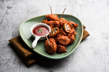 Mushroom 65, starter or appetiser food recipe from India. served in a plate with ketchup. selective...