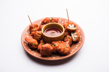 Mushroom 65, starter or appetiser food recipe from India. served in a plate with ketchup. selective focus