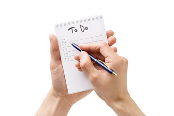 Man hands making a to-do list in a notebook. Isolated.