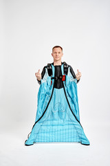 Fuck. Men in wing suit shows fuck by fingers. Skydiving men in parashute. Simulator of free fall.
