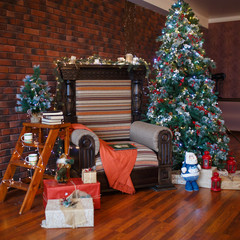 Decorated for The new year Interior of the house. Christmas tree and decorated Studio, garlands of lights, decorations, gift boxes in a cozy home, a large armchair and a fireplace.