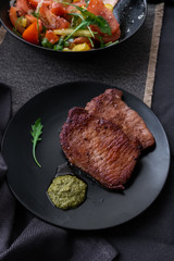 fried meat with vegetable salad and pesto. 