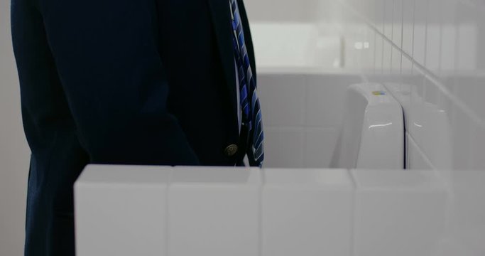 Businessman peeing in wc. Close up