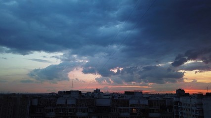 Nightfall over the big city. Fast moving clouds.