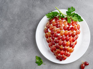 Healthy appetizer, tiffany chicken and cheese salad in the shape of cluster (bunch) of grapes on...