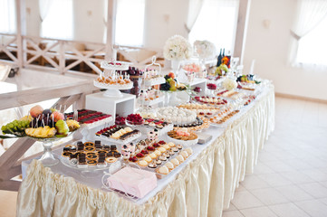 Beautiful wedding set decoration in the restaurant. Candy bar.