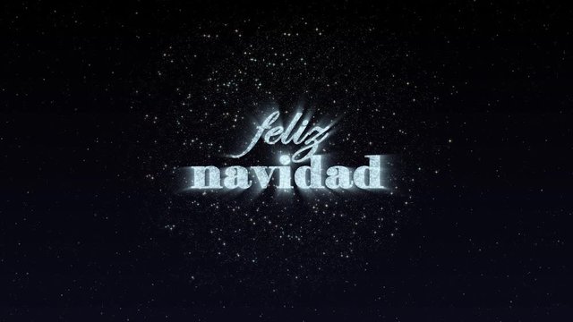 Feliz Navidad, spanish language text animation with fireworks and colorful particles. Translation: Merry Christmas