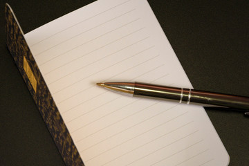 Open empty white notebook and pen, top view, copy space