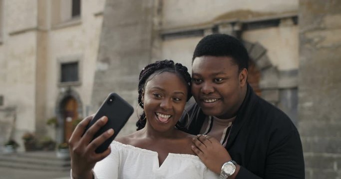 Happy african couple doing selfie.
