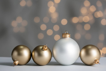 Beautiful Christmas balls on table against blurred lights