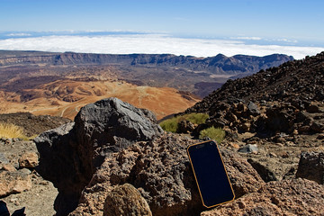 smartphone at the peak near the volcanic crater near the Teide volcano, oxamite mountain on the...