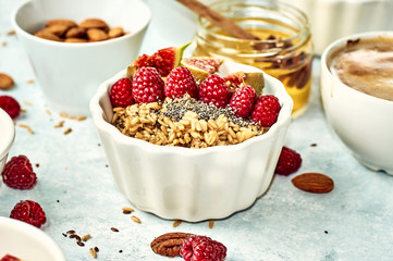 Oatmeal porridge with raspberry and figs in a bowl