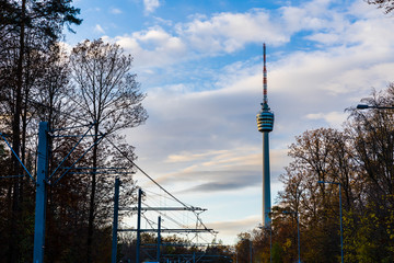 Germany, Urban city view to famous landmark tv tower in city of stuttgart behind colorful trees in autumn season