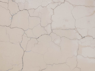 Fototapeta premium Cracks on the plastered wall surface. Abstract background texture concept
