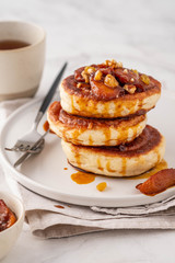 Pancake stacked with maple syrup and apple fruit. Copy space.