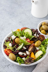 Salad of fresh vegetables and herbs with olives and feta cheese.
