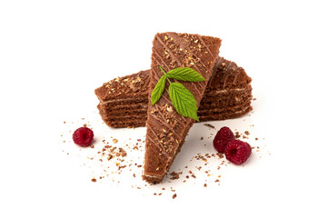 Slice of chocolate cake with milk filling and raspberry isolated on white background.