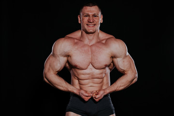 Fototapeta na wymiar the athlete bodybuilder shows his muscles after sports