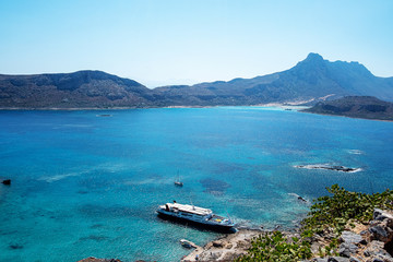 large tourist boat in a quiet Bay against the mountains