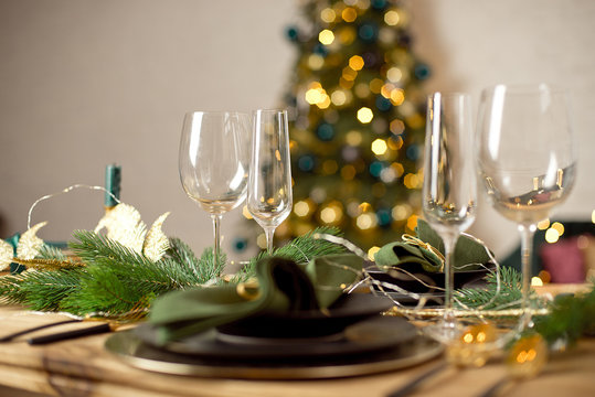 Table served for Christmas dinner in living room, close-up view, table setting, Christmas decoration