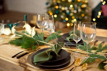Table served for Christmas dinner in living room, close-up view, table setting, Christmas decoration