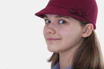 Three quarter closeup portrait of a girl in a red hat on a white background