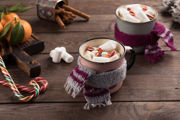 Christmas marshmallows in a drink Christmas decorations and tangerines on a wooden background. Winter holidays, new year mood. Copy space. Close up. Banner.