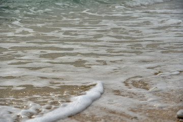 Foam of the Sea Waves on the Pebble Beach