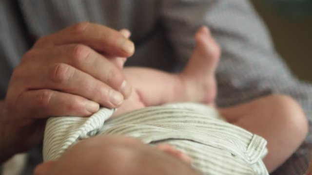 Newborn With Grandparents - Grandparent Holding Baby's Hand - Closeup Shot