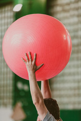 Man performs exercise with big ball