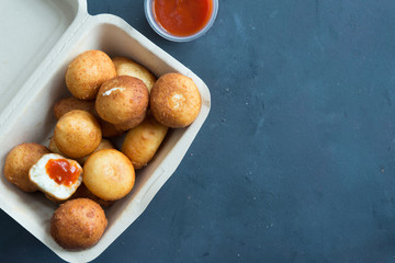 Fried Risotto Arancini stuffed with cheese, served with tomato sauce