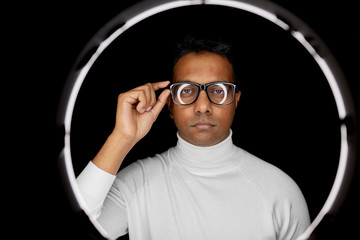 future technology, augmented reality and vision concept - indian man in glasses over white...
