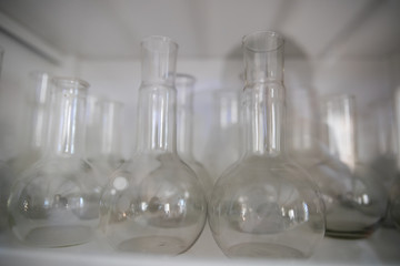 white orchid flower on glass flask and test tube in science cosmetic biology laboratory background