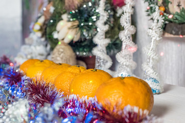 Fototapeta na wymiar Close up of fresh organic tangerines with christmas decorations, horizontal shot, selective focus