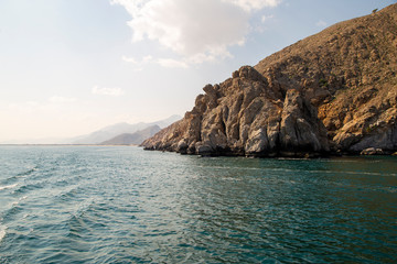 mountains of Oman on the sea against the blue sky