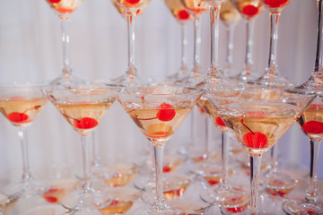 Martini glasses and cherries are on the table