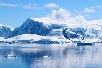 Fototapeta na wymiar Snow-capped mountains on an island along the coasts of the Antarctic Peninsula, Palmer Archipelago, Antarctica