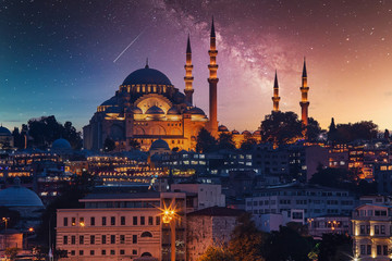 View to Eminonu pier and Suleymaniye mosque across Bay of Golden Horn on starry night - obrazy, fototapety, plakaty