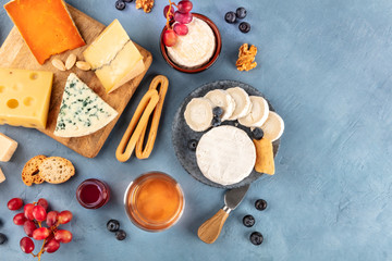 Cheese platter, a flat lay overhead shot. Blue cheese, red Leicester, Emmental, goat cheese, Brie...